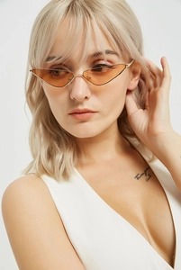 Close-up of stylish orange cat-eye sunglasses with slim gold frames on model face