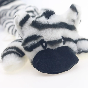 Close-up of zebra plush pet toy featuring embroidered eyes and black-and-white stripes
