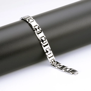 Polished silver stainless steel men's link bracelet wrapped on a black cylinder