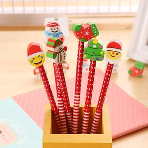 Christmas HB pencils set with holiday erasers in a yellow wooden holder on desk