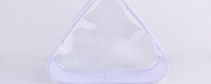 Detail of transparent PVC travel pouch with purple trim and smooth metal zipper