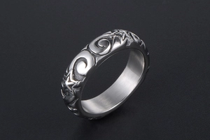 Macro detail of retro star ring featuring vintage swirl engravings and metallic luster