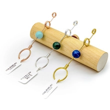 Detailed macro view of long metal bookmarks with natural gemstones in gold and silver finish