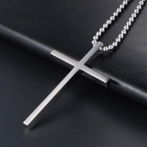 Minimalist silver titanium steel cross pendant necklace on black leather texture surface