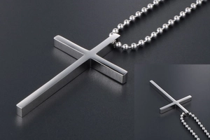 Detailed close-up of polished silver titanium cross pendant with elegant bead chain