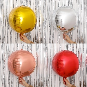 Close-up of metallic round foil balloons in gold, silver, rose gold, and red shades