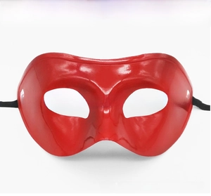 Detail of red half-face masquerade mask with glossy finish and black elastic strap