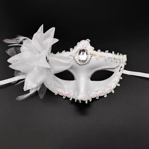 Venice white half-face mask with tulle flowers, feathers and sequins on black background