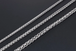 Detailed view of three stainless steel dragon bone chains in various thicknesses