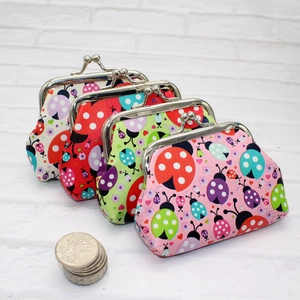Detail of ladybug coin purses with metal clasps and coins for size reference