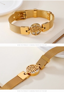 Detail of tree of life charm on golden mesh bracelet with white pearl background
