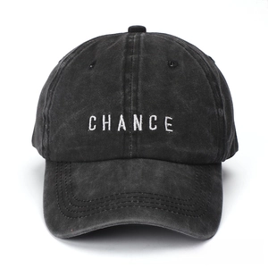 Detail of CHANCE embroidery on black washed cotton baseball cap with vintage finish