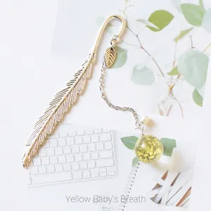Silver metal feather bookmark with yellow dried flower pendant and pearl leaf charm