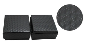 Detailed close-up of black jewelry gift box featuring elegant quilted pattern textures