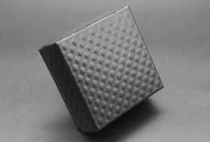 Detailed view of square black jewelry gift box with elegant embossed diamond pattern texture