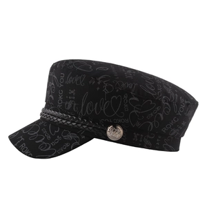 Black nautical flat top hat with graffiti prints, leather braid, and silver metal button