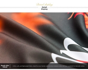 Close-up of soft peach skin fabric featuring vibrant orange and black geometric patterns