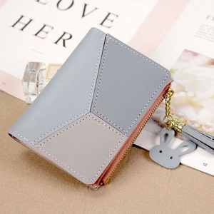 Short zipper wallet for women with geometric color block design and tassel charm