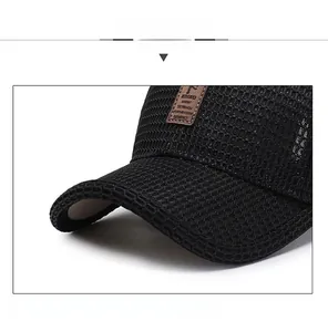 Detail of a black mesh baseball cap with a firm brim and leather logo patch