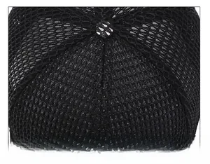 Close-up of top stitching and mesh texture on a black breathable baseball cap