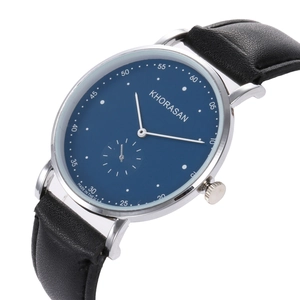 Detail view of quartz watch with navy blue dial, silver casing, and black leather strap