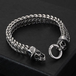Punk style silver skull bracelet in cast stainless steel on black leather background