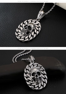 Macro detail of a silver punk skull pendant with a chain weave border on black leather