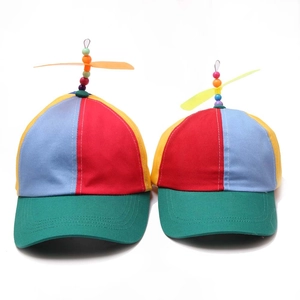 Detail of color-block propeller hat featuring a spinning top and canvas fabric