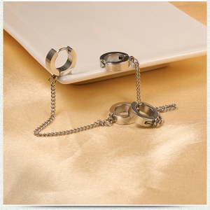 Silver stainless steel punk chain linked double hoop earrings on golden silk background