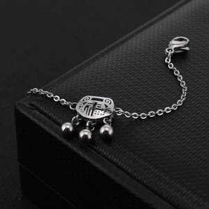 Detailed shot of silver longevity lock bracelet with hollow Fu character on black box