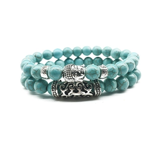 Handmade beaded bracelet set featuring blue turquoise stones and silver Buddha head charm