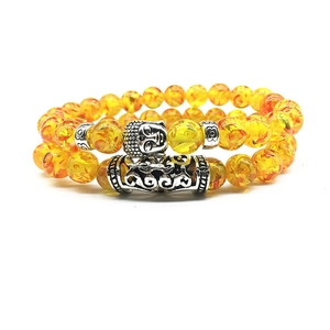 Ethnic double beaded bracelet with translucent yellow beads and Buddha head charm