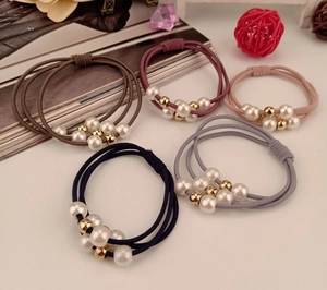 Close-up of triple-strand high-elastic hair ties with elegant faux pearls and gold beads
