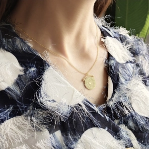 Minimalist 925 silver golden round disc pendant necklace worn by a fashion model
