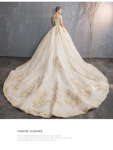 Detailed back view of champagne bridal gown with luxury embroidery and long train