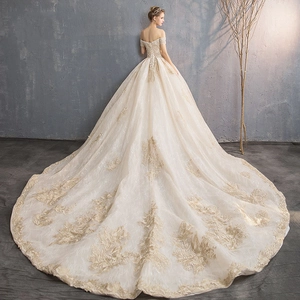 Luxury champagne off-shoulder bridal gown with cathedral train and floral lace embroidery