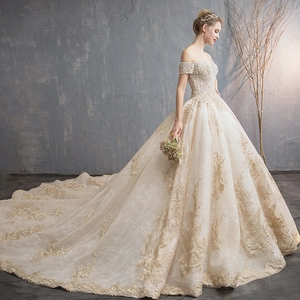 Luxurious off-the-shoulder champagne wedding gown with lace embroidery and long train
