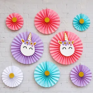 Detail of colorful paper fan decorations with golden foil unicorn designs and pastel colors