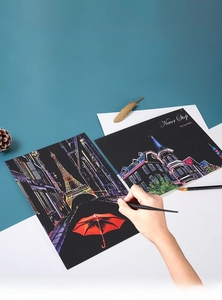 Detail of A4 city scratch art kit featuring Eiffel Tower design and wooden stylus tool