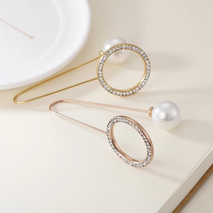 Elegant gold and rose gold brooch set with large pearls and sparkling rhinestones