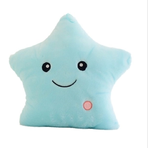 Blue star-shaped plush pillow with embroidered smiling face and soft velvet texture