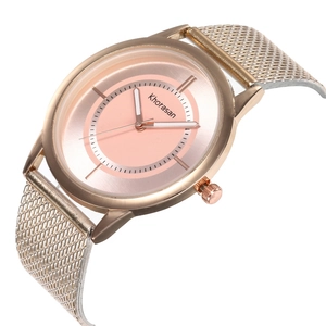 Detailed close-up of a women's rose gold mesh strap watch with a soft pink dial display