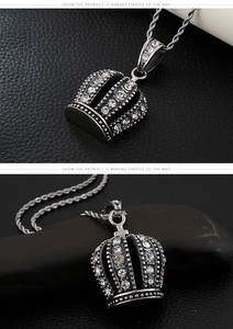 Close-up of hip hop crown pendant with inset rhinestones and twisted rope chain necklace