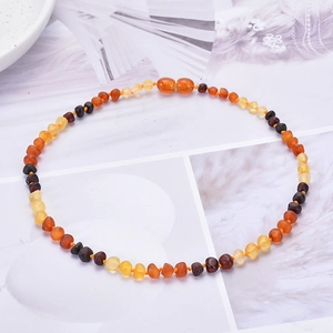 Macro detail of multicolored Baltic amber beads with secure safety knots and screw clasp