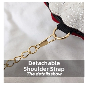 Detail of detachable shoulder strap with golden lobster clasp on white glitter shell bag