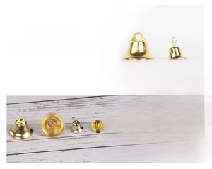 Close-up of shiny gold craft bells in two sizes for DIY Christmas tree decorations