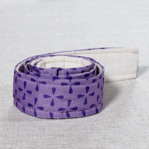 Macro detail of purple quilted cake bake even strip with elegant clover pattern