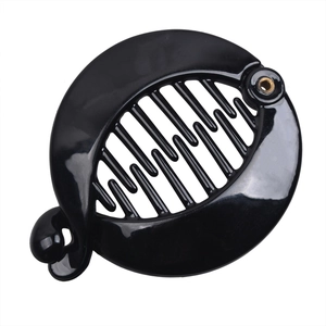 Close-up of black glossy banana hair clip with interlocking teeth and metal hinge detail