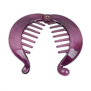 Detailed view of a purple translucent banana hair clip with secure metal hinge and teeth