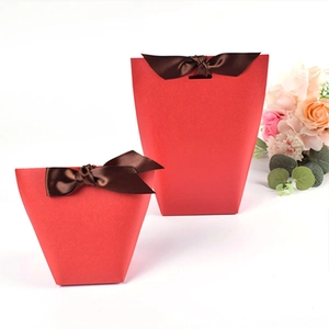 Elegant red pearlescent gift boxes with brown silk ribbons and floral decor